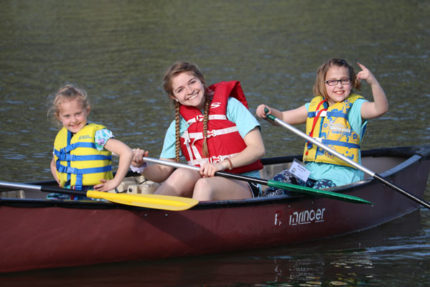 summer camp girls in canoe